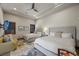 A spacious bedroom with two beds, a comfortable yellow sofa and neutral decor at 9301 Verlaine Ct, Las Vegas, NV 89145