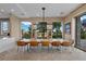 Elegant dining area with a large wooden table and natural light at 9301 Verlaine Ct, Las Vegas, NV 89145