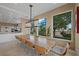 Dining room features a long wooden table with seating for ten, with a bright and airy atmosphere at 9301 Verlaine Ct, Las Vegas, NV 89145