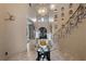 Elegant foyer featuring a wrought iron staircase, chandelier, and decorative accents at 9301 Verlaine Ct, Las Vegas, NV 89145