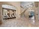 Grand foyer showcasing marble floors, a wrought iron staircase, and access to multiple rooms at 9301 Verlaine Ct, Las Vegas, NV 89145