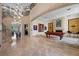 Expansive living area featuring a pool table, fireplace, and access to an elegant staircase at 9301 Verlaine Ct, Las Vegas, NV 89145