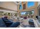 Bright living room with high ceilings, chic furnishings, and sliding glass doors to the outdoor living areas at 9301 Verlaine Ct, Las Vegas, NV 89145