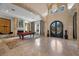 Spacious living room featuring a fireplace, pool table, arched doorways, and natural light at 9301 Verlaine Ct, Las Vegas, NV 89145