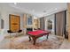 Elegant living room boasts a fireplace, pool table, and stylish decor at 9301 Verlaine Ct, Las Vegas, NV 89145