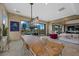 Open living space showcasing a long wooden table, comfortable seating, and outdoor access to the pool at 9301 Verlaine Ct, Las Vegas, NV 89145