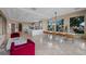 Open-concept area with dining table, kitchen, and lounge seating, filled with natural light at 9301 Verlaine Ct, Las Vegas, NV 89145