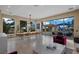 Open concept living space features long wooden table and chairs, with views of the backyard and pool area at 9301 Verlaine Ct, Las Vegas, NV 89145