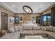 Opulent main bedroom retreat with plush seating, unique light fixture, and private balcony access at 9301 Verlaine Ct, Las Vegas, NV 89145