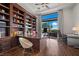 Luxury home office featuring custom built-ins, outdoor views, and modern furnishings at 9301 Verlaine Ct, Las Vegas, NV 89145