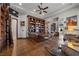 Spacious office with custom wood built-ins, ceiling fan, and wood floors at 9301 Verlaine Ct, Las Vegas, NV 89145