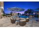 Extensive outdoor living space boasts a pool, spa, and comfortable seating for relaxation and entertainment at 9301 Verlaine Ct, Las Vegas, NV 89145