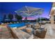 Luxurious outdoor living area with a pool, lounge chairs, and comfortable seating for relaxing by the pool at 9301 Verlaine Ct, Las Vegas, NV 89145