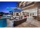 Beautiful outdoor living space with a covered patio, comfortable seating, and access to the sparkling pool at 9301 Verlaine Ct, Las Vegas, NV 89145