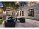 Outdoor patio area featuring comfortable seating and an elegant stone facade at 9301 Verlaine Ct, Las Vegas, NV 89145