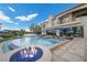 Luxury backyard pool features a fire pit, spa, and ample space for outdoor entertaining on the patio at 9301 Verlaine Ct, Las Vegas, NV 89145