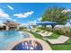 Backyard oasis featuring a pool, spa, fire pit, playground, and lounge chairs for relaxing and entertaining at 9301 Verlaine Ct, Las Vegas, NV 89145