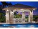 Covered poolside dining area offers a relaxing space for outdoor meals and entertaining guests at 9301 Verlaine Ct, Las Vegas, NV 89145