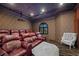 Theater room with large screen, comfortable seating, and dark walls for immersive viewing at 9301 Verlaine Ct, Las Vegas, NV 89145
