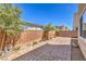 This backyard has pavers, a block wall, small plants, and a gravel border, ready for entertaining at 9326 Noble Sage Ave, Las Vegas, NV 89148