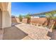 The backyard features brick pavers, small plants, a block wall and a gravel border at 9326 Noble Sage Ave, Las Vegas, NV 89148