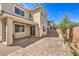 This backyard features brick pavers, small plants, and a patio door for entertaining at 9326 Noble Sage Ave, Las Vegas, NV 89148