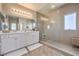 Modern bathroom featuring a glass-enclosed shower, double sink vanity, and neutral color palette at 9326 Noble Sage Ave, Las Vegas, NV 89148