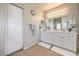 Bright bathroom with double sinks, white cabinetry, and ample storage space for toiletries at 9326 Noble Sage Ave, Las Vegas, NV 89148