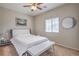 Comfortable bedroom featuring a ceiling fan, stylish decor, and a bench at the foot of the bed at 9326 Noble Sage Ave, Las Vegas, NV 89148