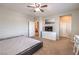 This bedroom features carpet, a ceiling fan, a closet, and a dresser with a television set at 9326 Noble Sage Ave, Las Vegas, NV 89148