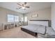 Bright bedroom featuring a ceiling fan and a dedicated workspace with a desk and shelving at 9326 Noble Sage Ave, Las Vegas, NV 89148