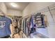 Organized walk-in closet with hanging rods, shelving, and ample storage for clothing and accessories at 9326 Noble Sage Ave, Las Vegas, NV 89148