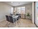 Cozy dining area with modern table set, buffet cabinet and natural light from the sliding door at 9326 Noble Sage Ave, Las Vegas, NV 89148