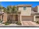 Inviting two-story home with a two-car garage and stone accents on the facade and well-manicured landscaping at 9326 Noble Sage Ave, Las Vegas, NV 89148