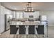 Bright kitchen boasts granite counters, stainless appliances, white cabinets, and island seating at 9326 Noble Sage Ave, Las Vegas, NV 89148