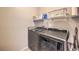 A modern laundry room featuring new appliances and storage shelves for detergent and other cleaning products at 9326 Noble Sage Ave, Las Vegas, NV 89148