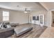Open living room with modern furnishings, ceiling fan and tile flooring at 9326 Noble Sage Ave, Las Vegas, NV 89148