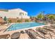Community pool with plenty of lounge chairs for residents to relax and enjoy the summer sun at 9326 Noble Sage Ave, Las Vegas, NV 89148