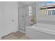 Bathroom featuring a soaking tub, a walk-in shower with glass door, and a linen closet at 9590 Smiley Creek St, Las Vegas, NV 89178