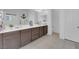 Bathroom featuring a double sink vanity with dark cabinetry, tile flooring, and a toilet at 9590 Smiley Creek St, Las Vegas, NV 89178