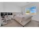 Comfortable bedroom with a plush bed, natural light, and a small desk at 9590 Smiley Creek St, Las Vegas, NV 89178