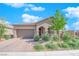 Charming single-story home with a two-car garage, desert landscaping, and a tile roof at 9590 Smiley Creek St, Las Vegas, NV 89178