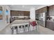 Open kitchen featuring a large island with seating, stainless steel appliances, and ample cabinet space at 9590 Smiley Creek St, Las Vegas, NV 89178