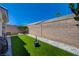 Private backyard featuring artificial turf, desert landscaping, and block wall for privacy at 9724 Canyon Walk Ave, Las Vegas, NV 89147