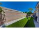 Landscaped backyard featuring artificial turf, a block wall, and low maintenance desert landscaping at 9724 Canyon Walk Ave, Las Vegas, NV 89147