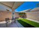 Relaxing backyard patio area with artificial turf, seating area, and privacy walls at 9724 Canyon Walk Ave, Las Vegas, NV 89147