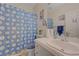 Bright bathroom featuring daisy-themed shower curtain, white vanity, and clean finishes at 9724 Canyon Walk Ave, Las Vegas, NV 89147