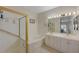 Bathroom featuring a shower and tub with double sinks and large mirror at 9724 Canyon Walk Ave, Las Vegas, NV 89147
