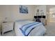 Bright bedroom featuring a bed, desk with monitors, and view into the primary bathroom at 9724 Canyon Walk Ave, Las Vegas, NV 89147