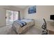 Comfortable bedroom with sliding glass doors to the backyard and contemporary decor at 9724 Canyon Walk Ave, Las Vegas, NV 89147